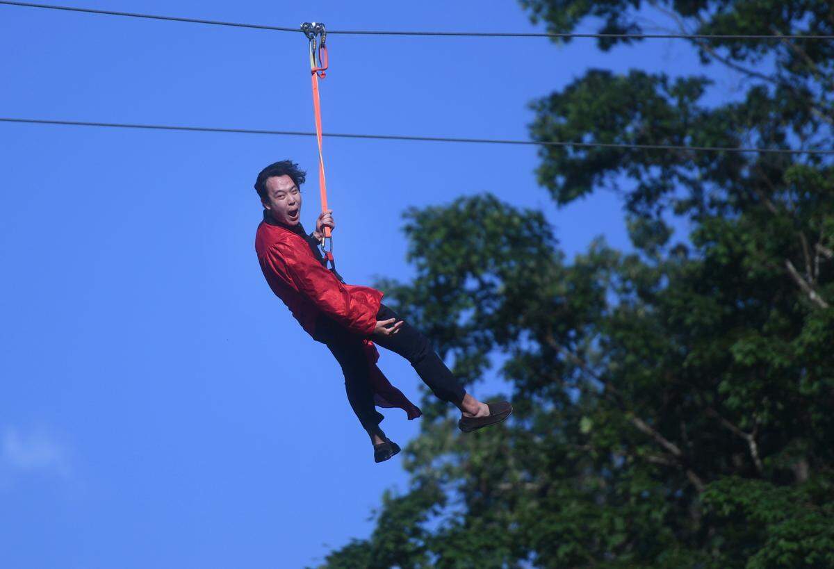 Kanghyuk Lee celebrates as he zip lines over for the Grace Prep graduation on Friday, June 2, 2023 at Camp Kanesatake.