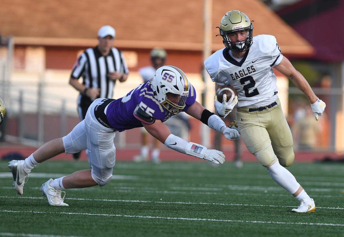 Bald Eagle Area’s Beau Taylor (2) evades a tackle from a Bishop Guilfoyle defender in the first quarter Saturday at Altoona’s Mansion Park.