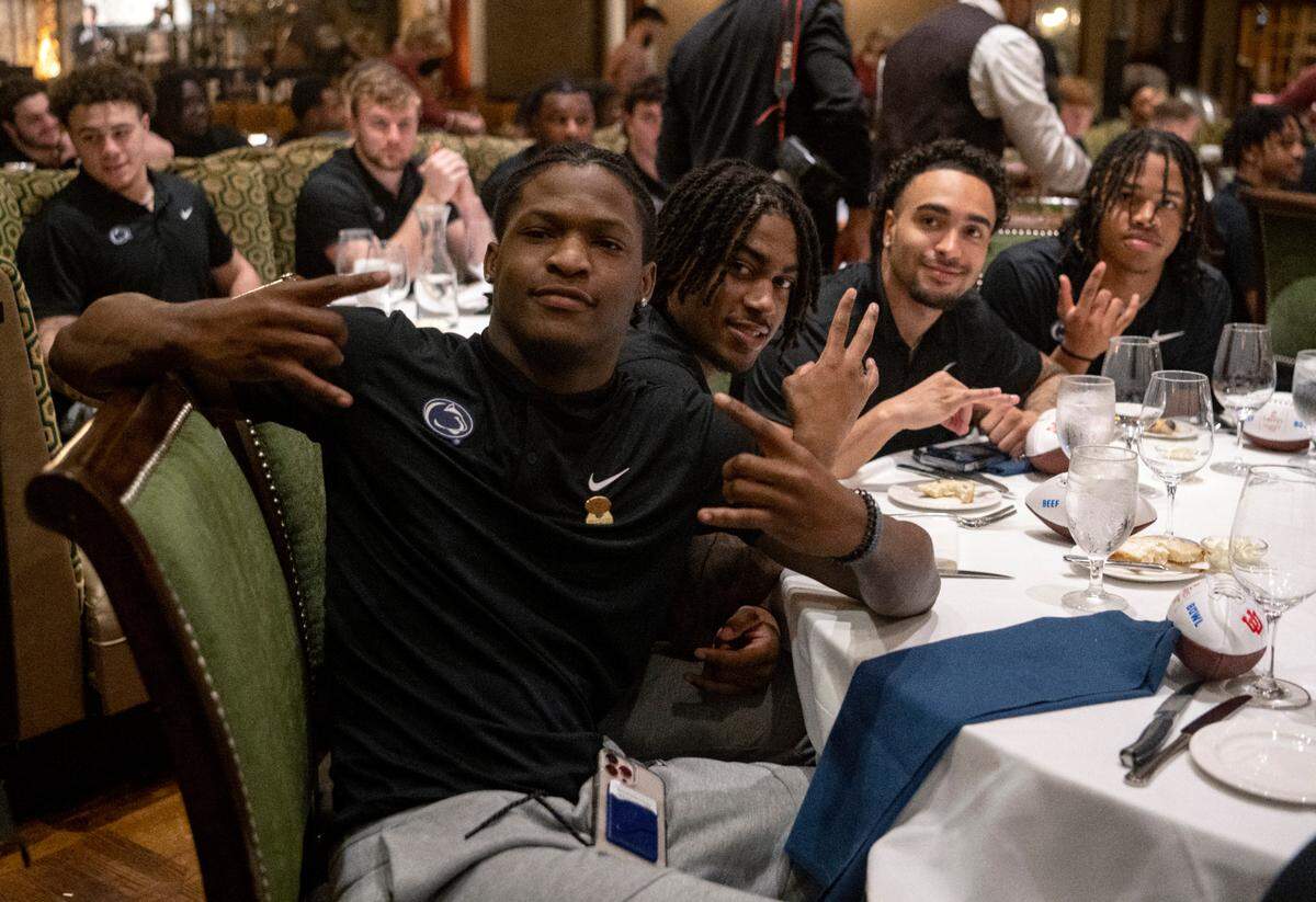 Penn State football wide receivers Anthony Ivey, Tyler Johnson, Kaden Saunders and Omari Evans sit together at the Lawry’s Beef Bowl on Friday, Dec. 30, 2022.