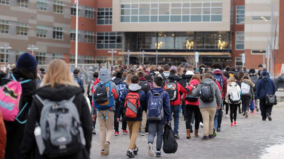 Students cross the street to enter the new State College High School building Monday, Jan. 8, 2018.