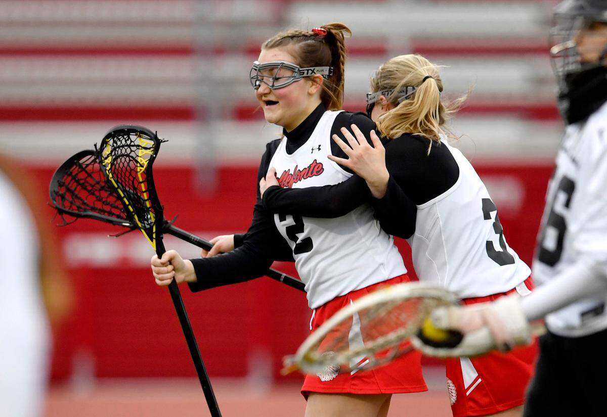 Bellefonte’s Molly McKee is hugged by teammates after getting her 100th goal during the game against Selinsgrove on Tuesday.