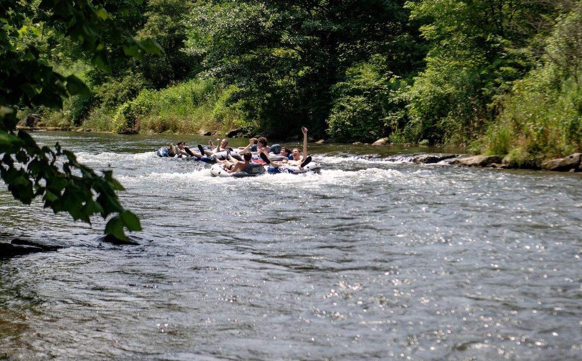 A group of friends from State College go over a small rapid as they float down Spring Creek towards Milesburg on Friday, June 21, 2024.