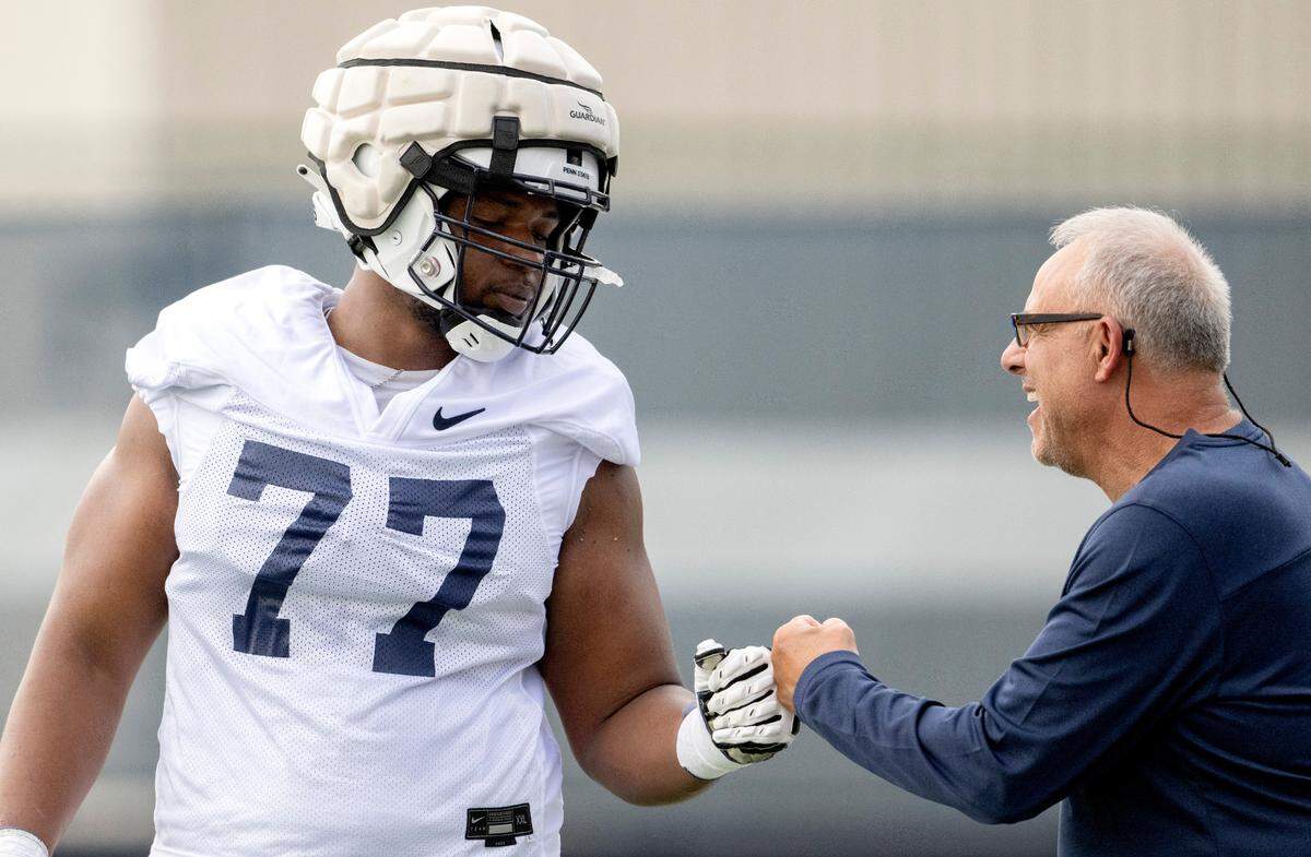 Penn State offensive lineman Sal Wormley gives a fist bump during the first day of practice on Monday, Aug. 1, 2022.