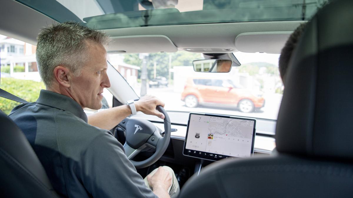 John Franek Jr. Drives a Tesla Model 3 with Telsa representative Dylan Gumbel during an information session on electric cars in Bellefonte on Aug. 9.