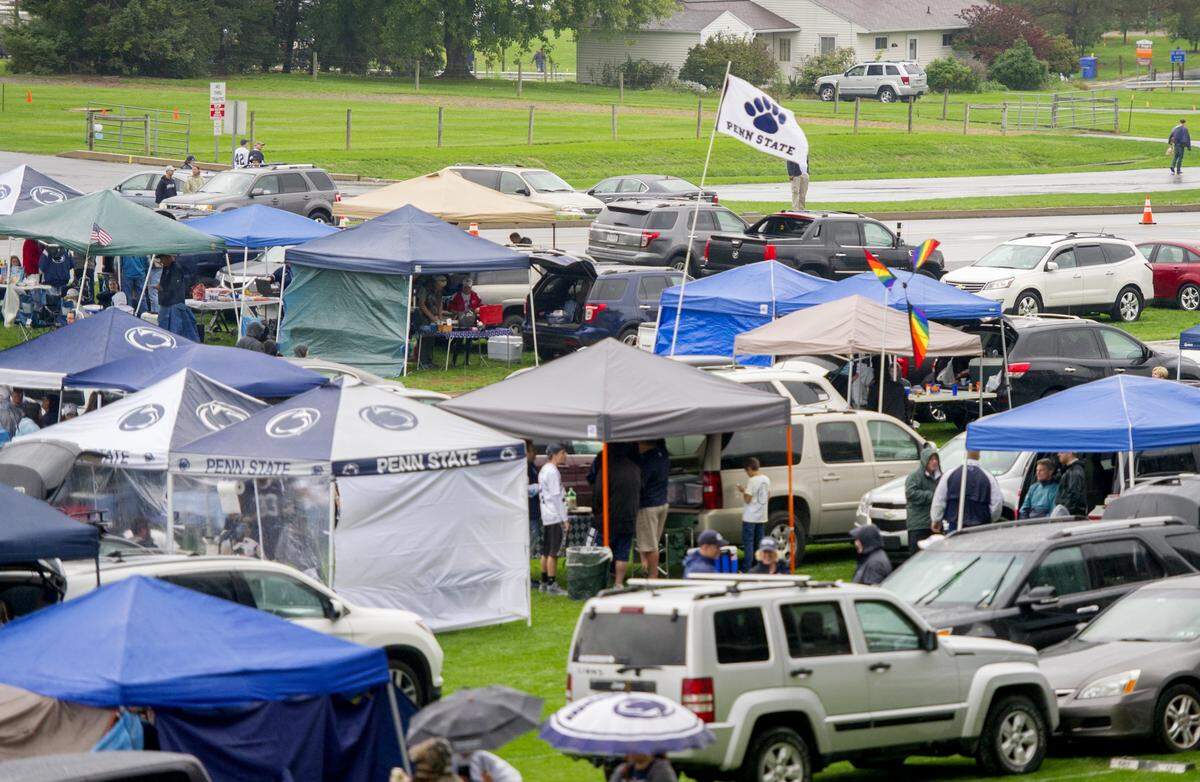 Tailgaters brave the rain outside of Beaver Stadium before the Saturday, October 8, 2016 game.  Penn State restricted parking on grassy RV lots outside of Beaver Stadium ahead of Saturday’s game against Iowa.