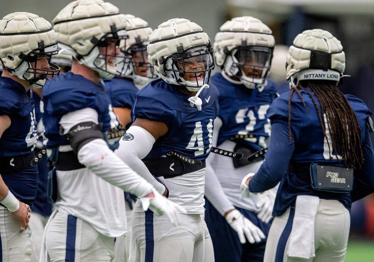 Penn State linebacker Kobe King and his teammates talk about a drill during practice on Friday, Dec. 17, 2021.