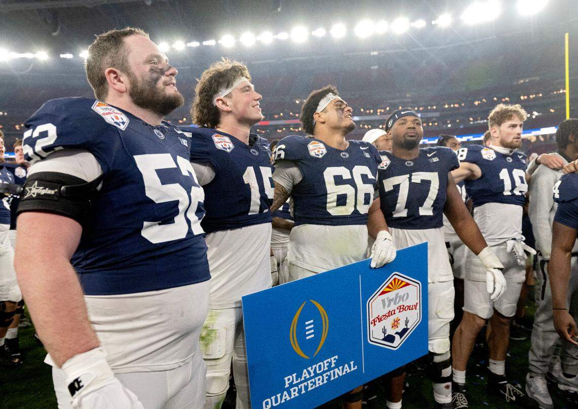 Penn State quarterback Drew Allar (15) sings the alma mater with offensive linemen Dominic Rulli, Drew Shelton and Sal Wormley after beating Boise State 31-14 in the Fiesta Bowl on Tuesday, Dec. 31, 2024 at State Farm Stadium.