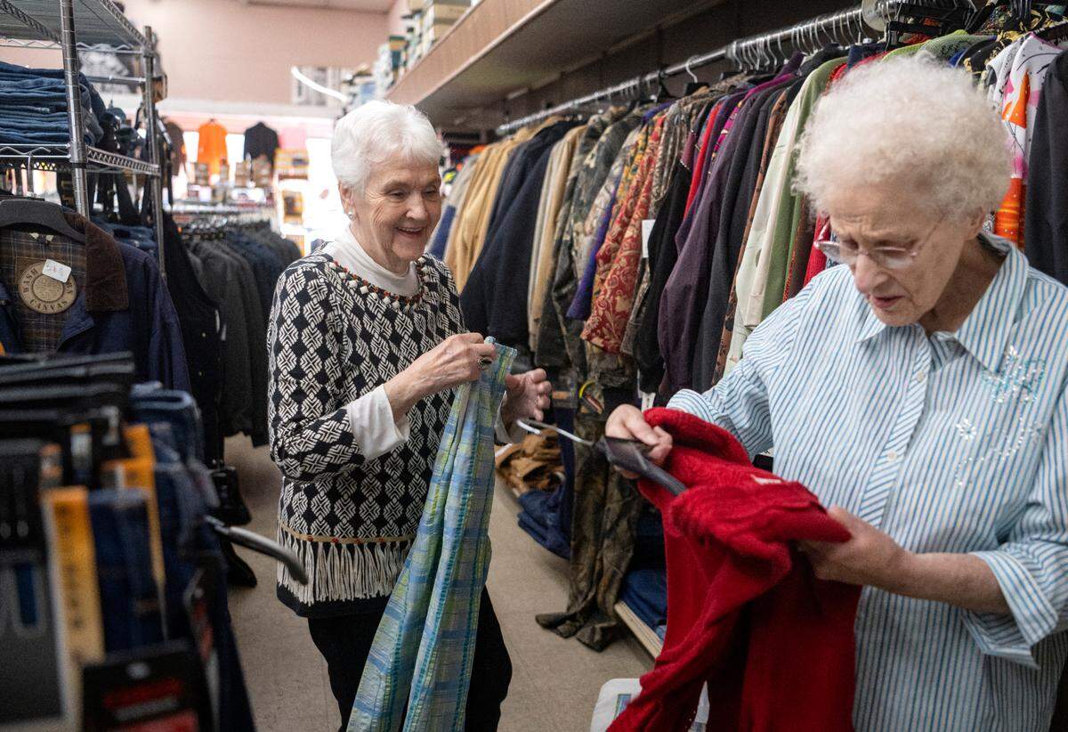 Judy Rothrock helps a customer looks through sale items at Rothrocks Clothing and Shoes on Front Street in Philipsburg on Feb. 8, 2023.