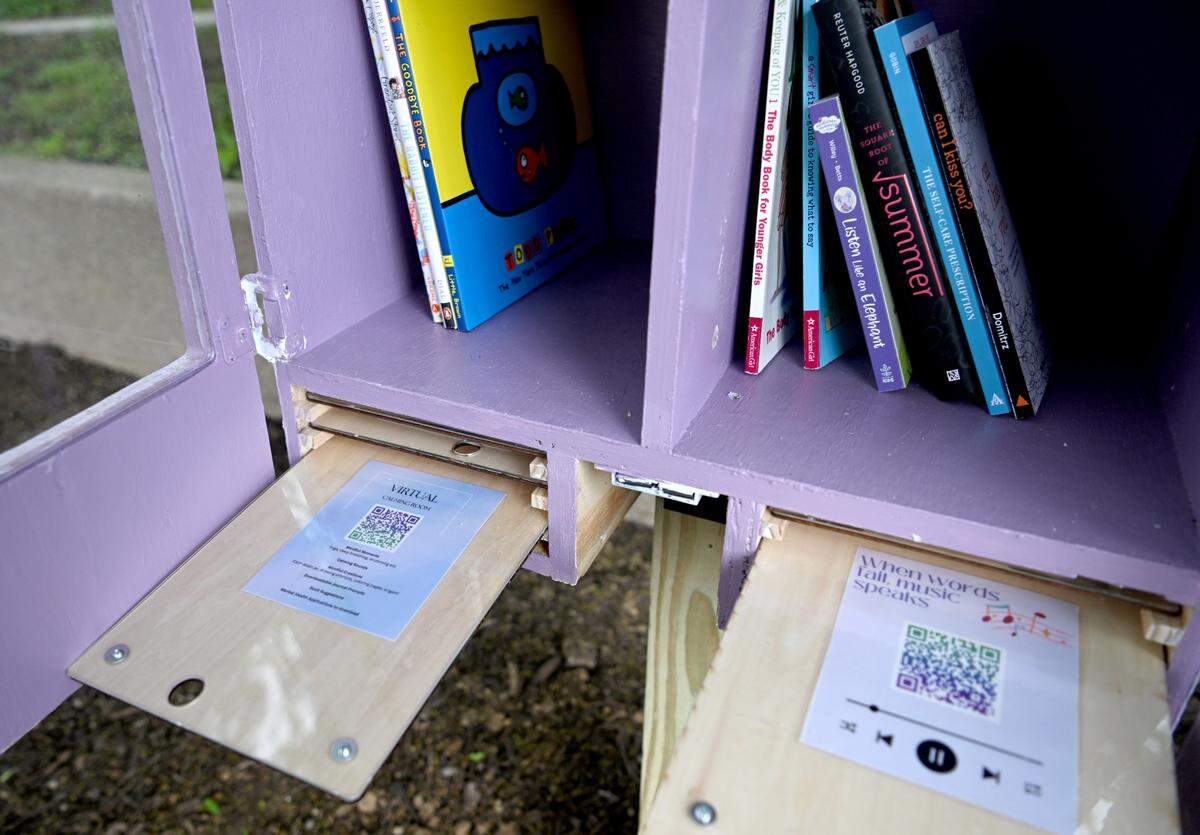 Pull-out drawers offer mental health tips and QR codes to visitors of the Tranquility Station at Sidney Friedman Park. The Reach Club from the Jana Maria Foundation created the station.