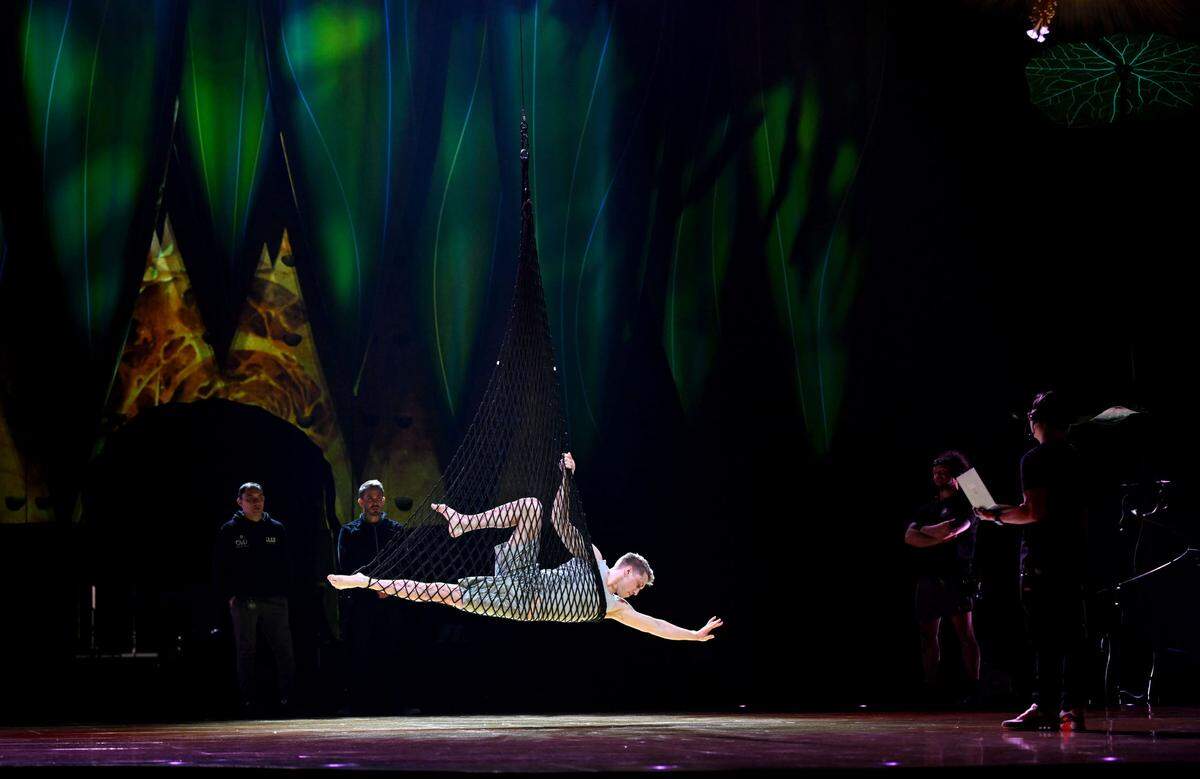 The artist and technical team watch as Beau Sargent rehearses his aerial net routine in Cirque du Soleil’s show “Ovo” at the Bryce Jordan Center on Thursday, March 27, 2025.
