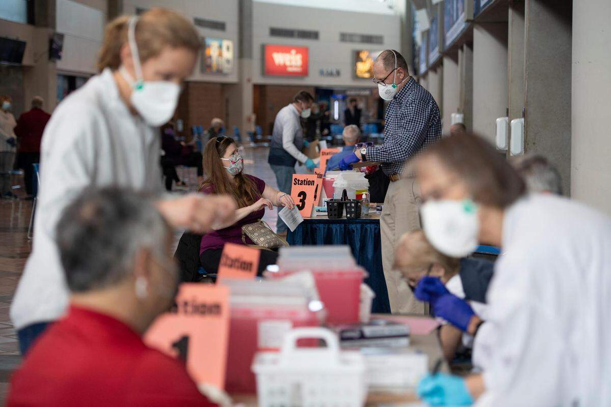 People receive COVID-19 vaccines at a Centre Volunteers in Medicine vaccine distribution site at the Bryce Jordan Center in March. Penn State and CVIM are again teaming up Sunday to offer another vaccine clinic.