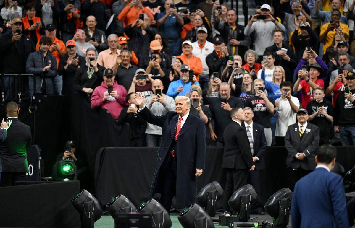 President Donald Trump waves to the crowd as he arrives at the 2025 NCAA Wrestling Championships at the Wells Fargo Center in Philadelphia on Saturday March 22, 2025.