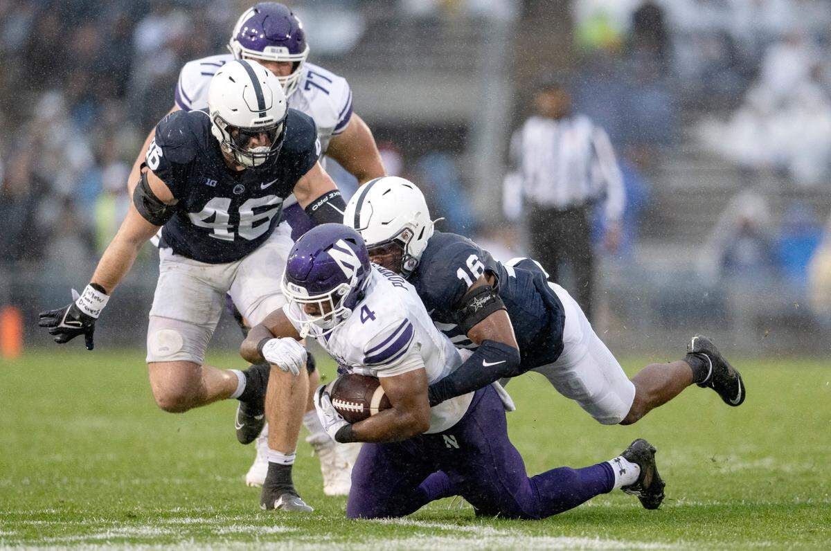 Penn State safety Ji’Ayir Brown tackles Northwestern’s Cam Porter during the game on Saturday, Oct. 1, 2022.