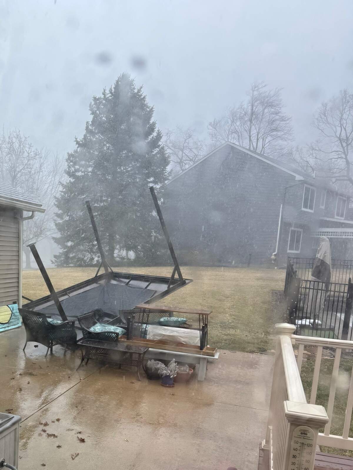 An overturned gazebo is pictured in a Clover Highlands backyard in State College.