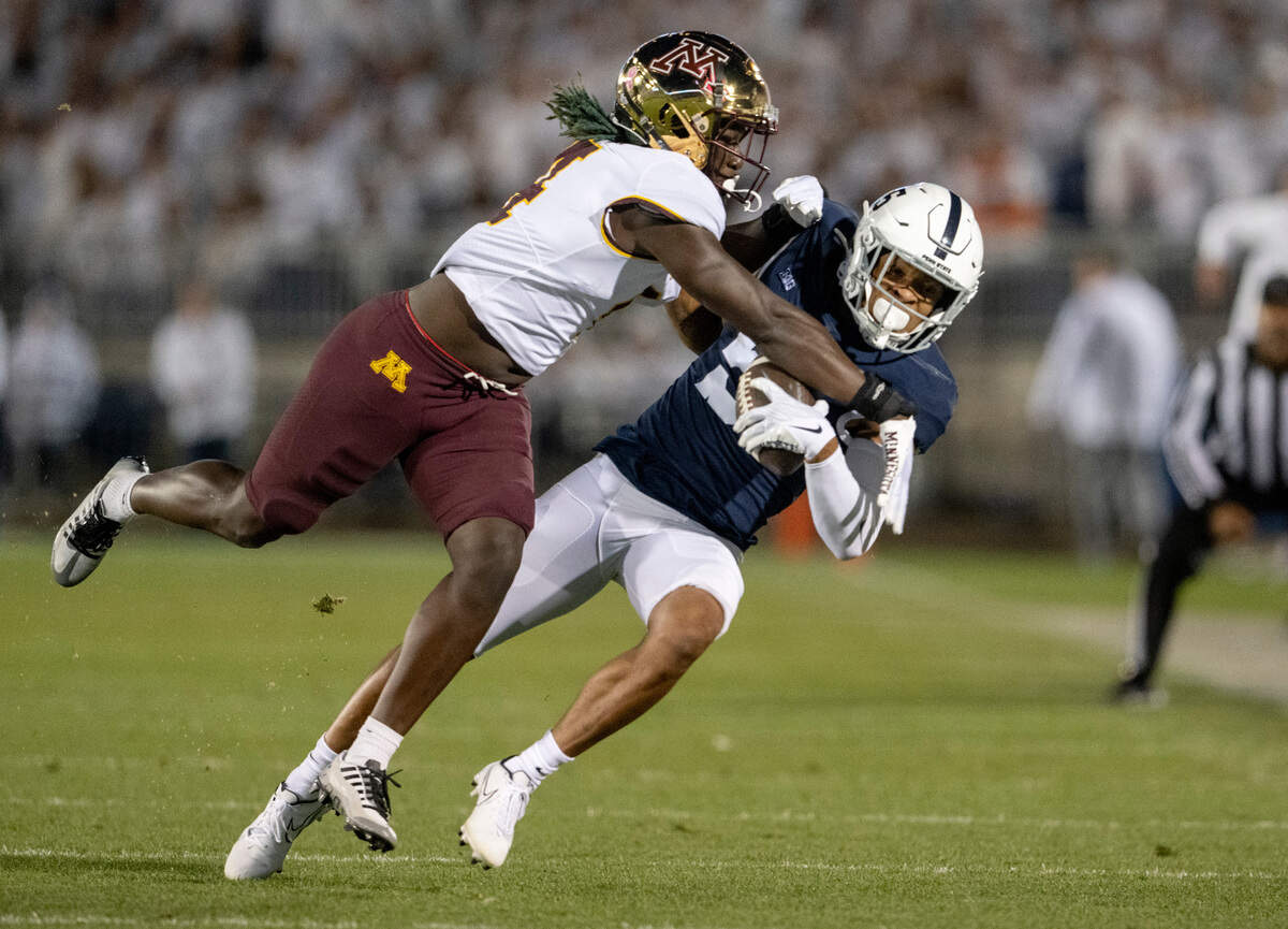 Penn State wide receiver Mitch Tinsley makes a catch around Minnesota’s Terell Smith during the game on Saturday, Oct. 22, 2022.