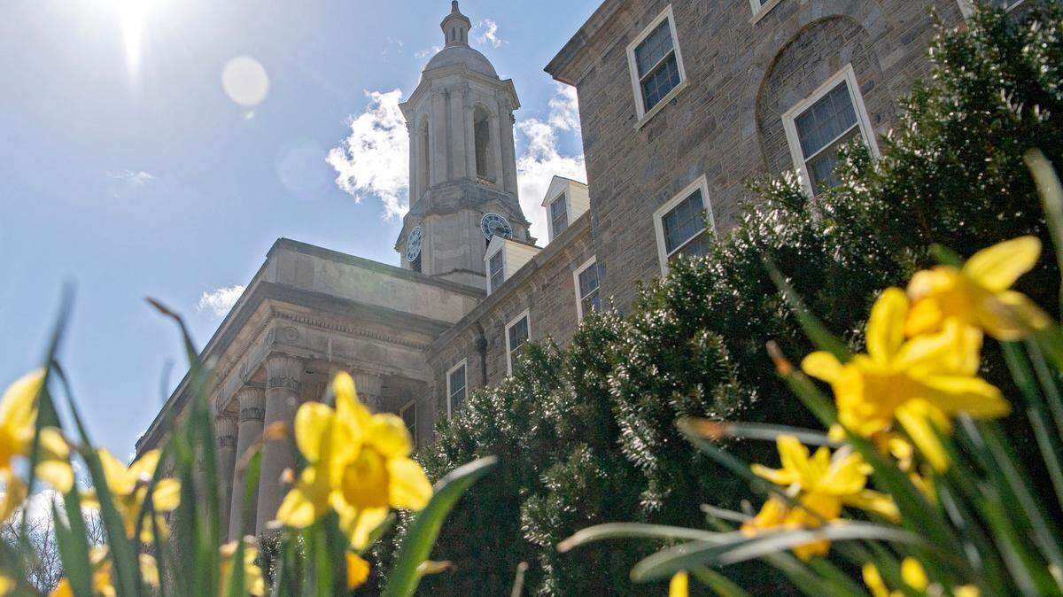 Flowers bloom in front of Old Main on the Penn State campus on Tuesday, April 12, 2022.