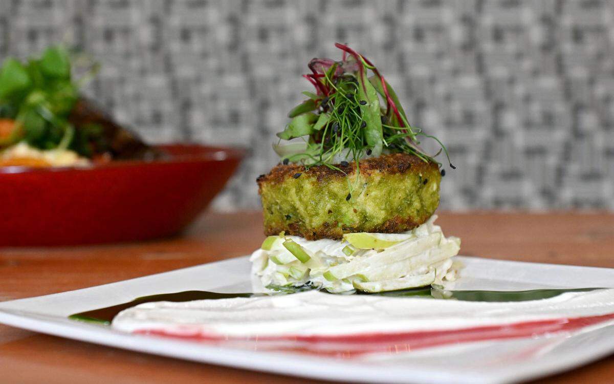 The jumbo lump crab cake at Gigi’s Southern Table. Jumbo lump crab, Granny Smith apple, basil infused oil, apple slaw with raspberry vinegar and Goldschlager cream fraiche.
