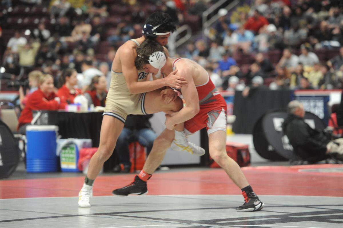 Bellefonte’s Jude Swisher looks to finish off a single leg takedown on Council Rock South’s Sherm Sadriddinov in their 145-pound quarterfinals match of the PIAA Class 3A Championships on Friday, March 11, 2022 at Giant Center in Hershey. Swisher earned an 11-2 major decision to secure his third straight podium finish.