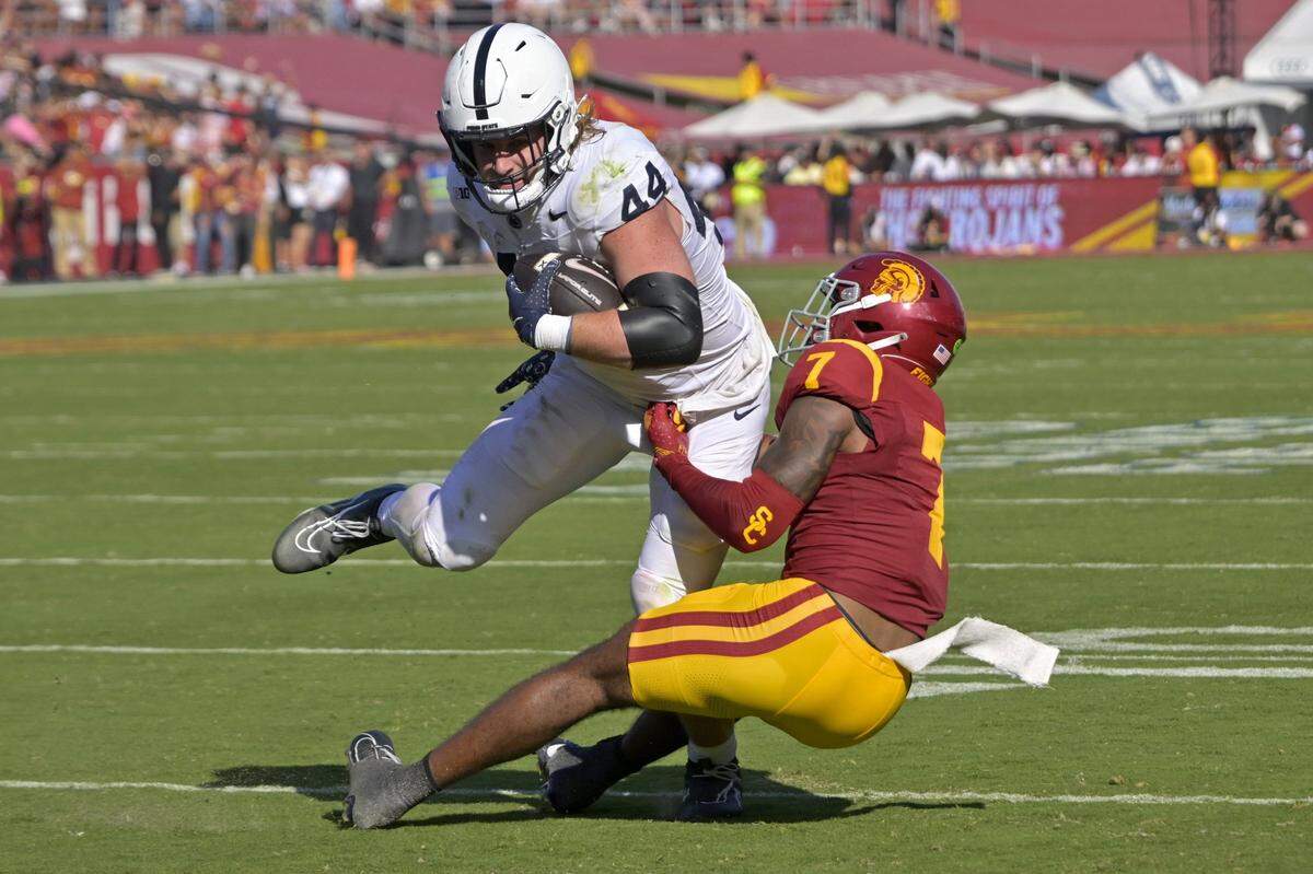 Oct 12, 2024; Los Angeles, California, USA;   Penn State Nittany Lions tight end Tyler Warren (44) is stopped by USC Trojans safety Kamari Ramsey (7) after a short gain in the second half at United Airlines Field at the Los Angeles Memorial Coliseum. Mandatory Credit: Jayne Kamin-Oncea-Imagn Images