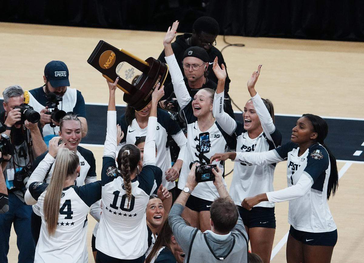 Penn State celebrated with the trophy after they defeated Louisville 3 sets to 1 to win the NCAA Championship Volleyball match at the KFC Yum! Center in Louisville, Ky. on Dec. 22, 2024.
