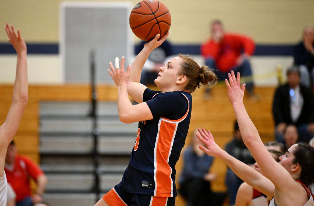 Saint Joseph’s Catholic Academy’s Naomi Crispin goes in for a basket over DuBois Central Catholic defenders during the game on Wednesday, March, 12, 2025 at Bald Eagle Area High School.