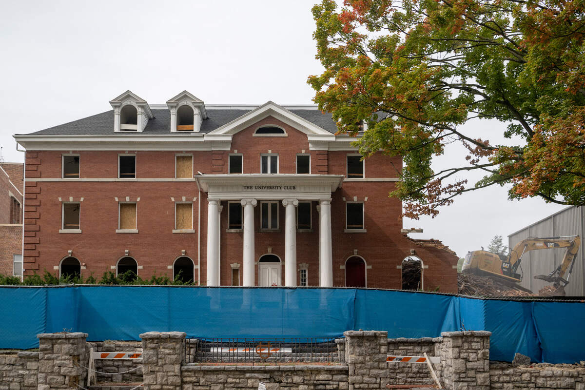 Crews work to demolish the University Club on College Avenue on Friday, Sept. 30, 2022.