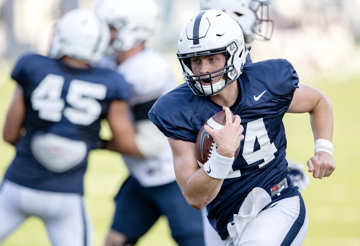 Penn State quarterback Sean Clifford runs with the ball during practice on Wednesday, Aug. 29, 2018.