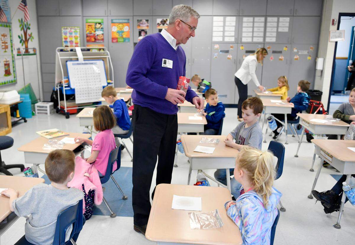 Pennsylvania Agriculture Secretary Russell Redding hands out kidney beans to kindergarten students at Howard Elementary to do a growing experiment on Tuesday, March 15, 2022.