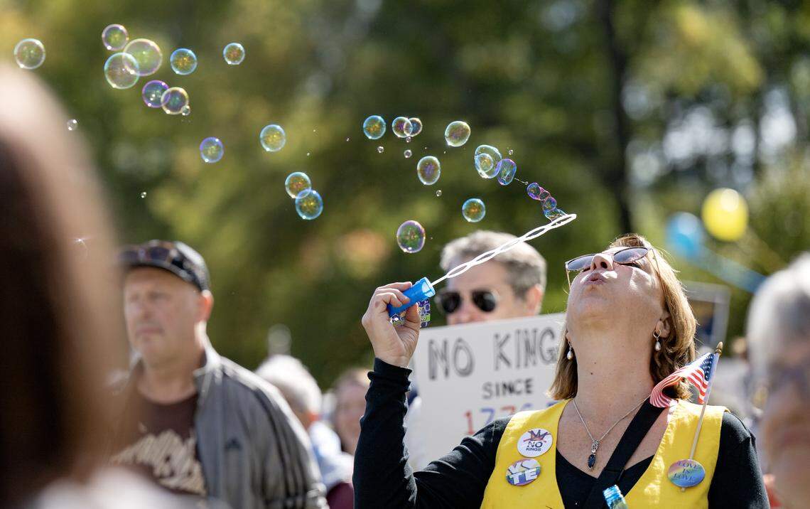 A protester blows bubbles as the No Kings anti-Trump rally was peaceful on Saturday, Oct. 18, 2025. 