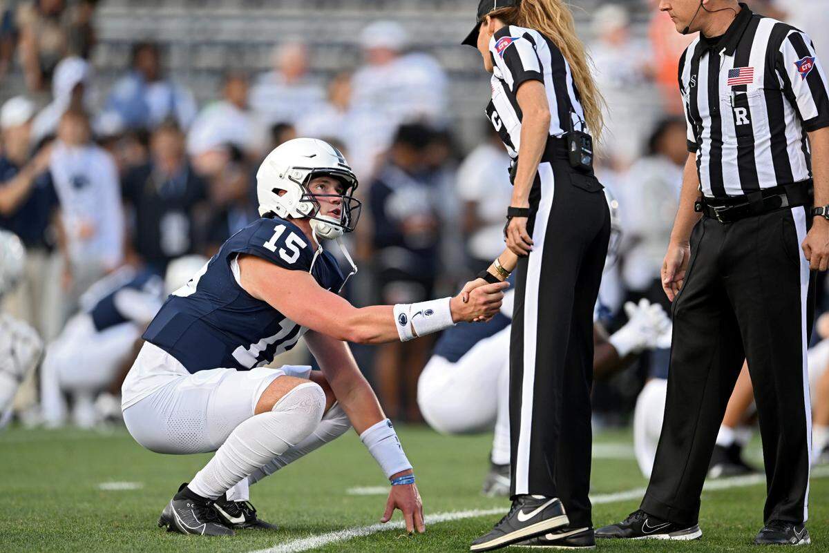Penn State quarterback Drew Allar shakes hands with the referees as he warms up for the game against West Virginia on Saturday, Sept. 2, 2023.