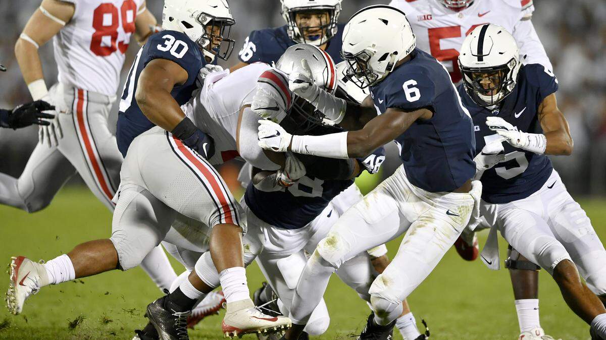 Penn State’s defense, including Kevin Givens, Shareef Miller and Cam Brown, pull down Ohio State’s ballcarrier during the game on Saturday, Sept. 29, 2018 at Beaver Stadium.