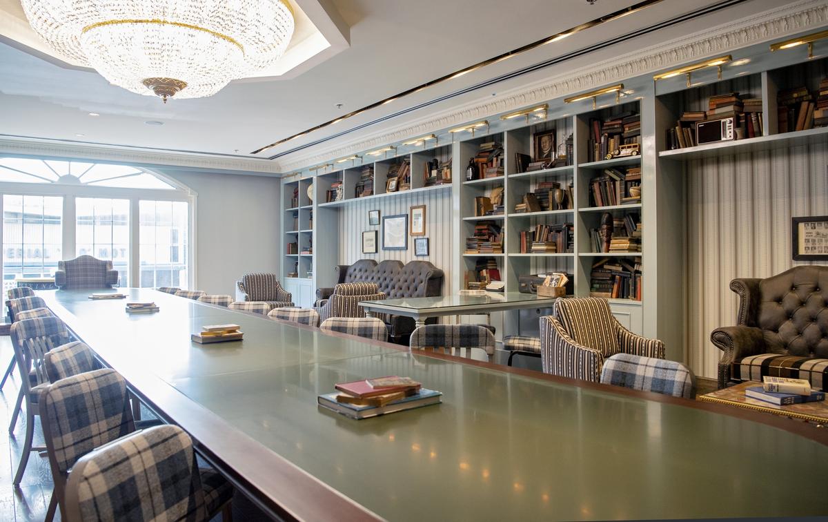 The lobby lounge at the Graduate State College offers small sitting areas, a large community table, and books welcome for guests to read.