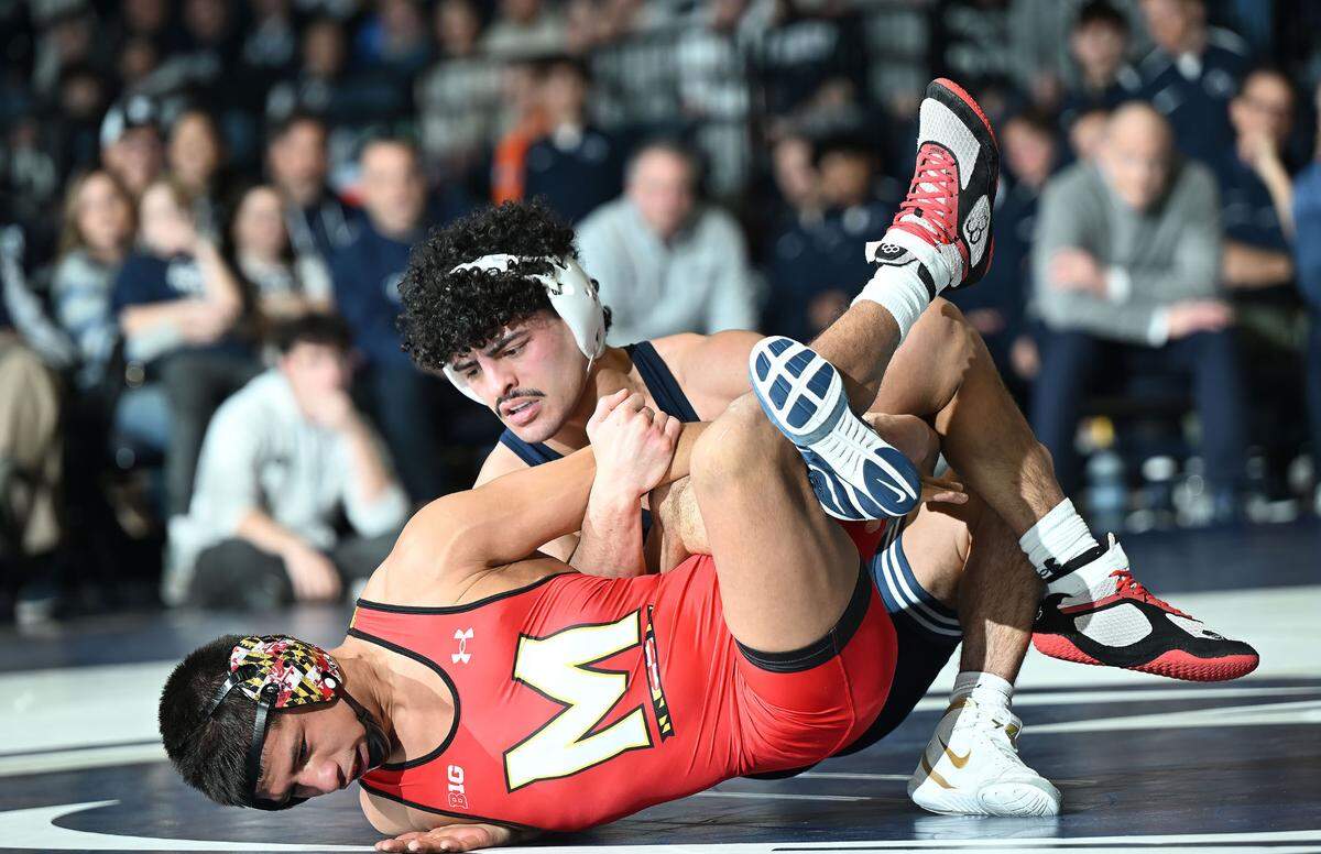 Penn State’s Beau Bartlett takes down Maryland’s Dario Lemus at 141 lbs. during Sunday’s meeting at Rec Hall in State College. Bartlett defeated Lemus, 17-3.