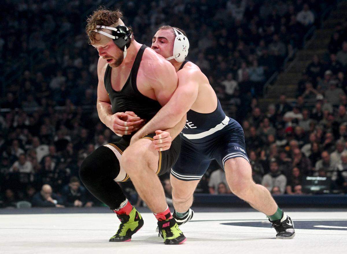 Iowa’s Jacob Warner tries to get away from Penn State’s Max Dean in the 197 lb bout of the match on Friday, Jan. 27, 2023. Dean won by decision, 2-0.