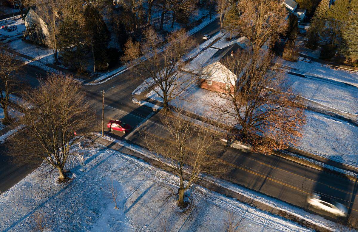 Cars drive past trees along South Atherton Street on Tuesday in State College. About 60 trees along a stretch of the street between Westerly Parkway and Curtin Road could be removed as part of an upcoming roadwork project by PennDOT.