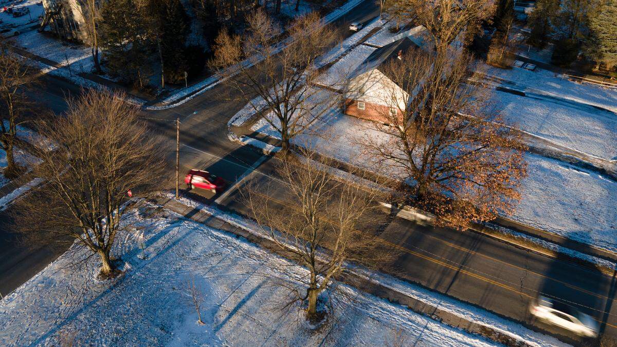 Cars drive past trees along South Atherton on Jan. 11 in State College.