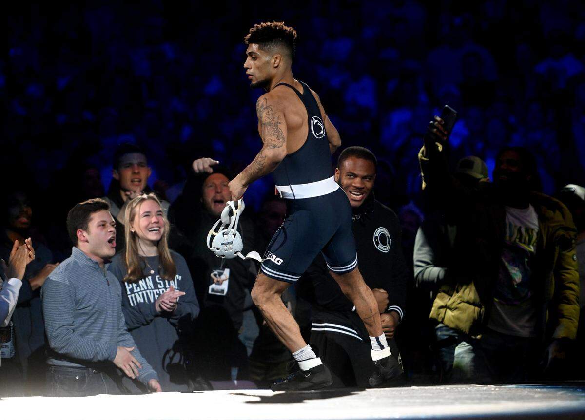 Penn State’s Roman Bravo-Young high-fives Micah Parsons after pinning Iowa’s Brody Teske in the 133 lb bout of the match on Friday, Jan. 27, 2023.