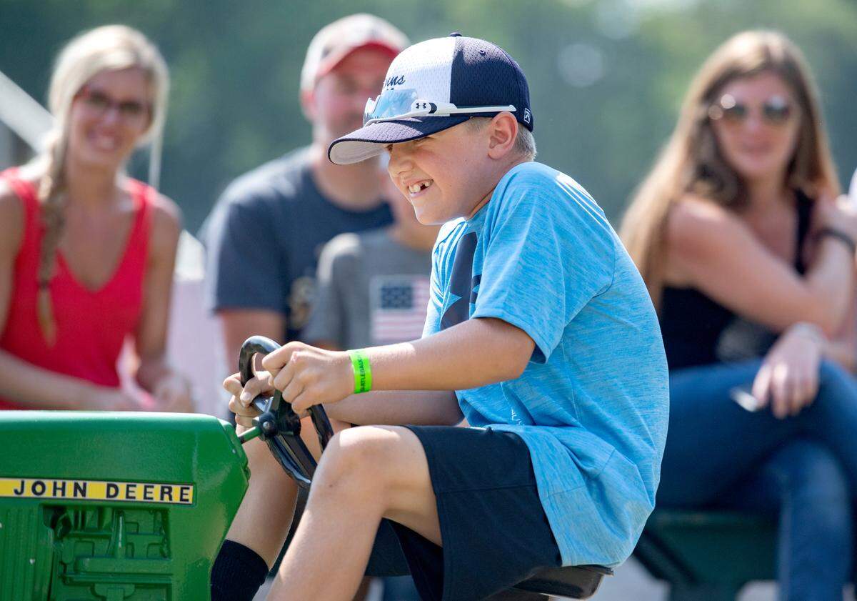 Rycen Musser, 7, concentrates as he competes in the pedal tractor pull Tuesday at the Centre County Grange Fair.