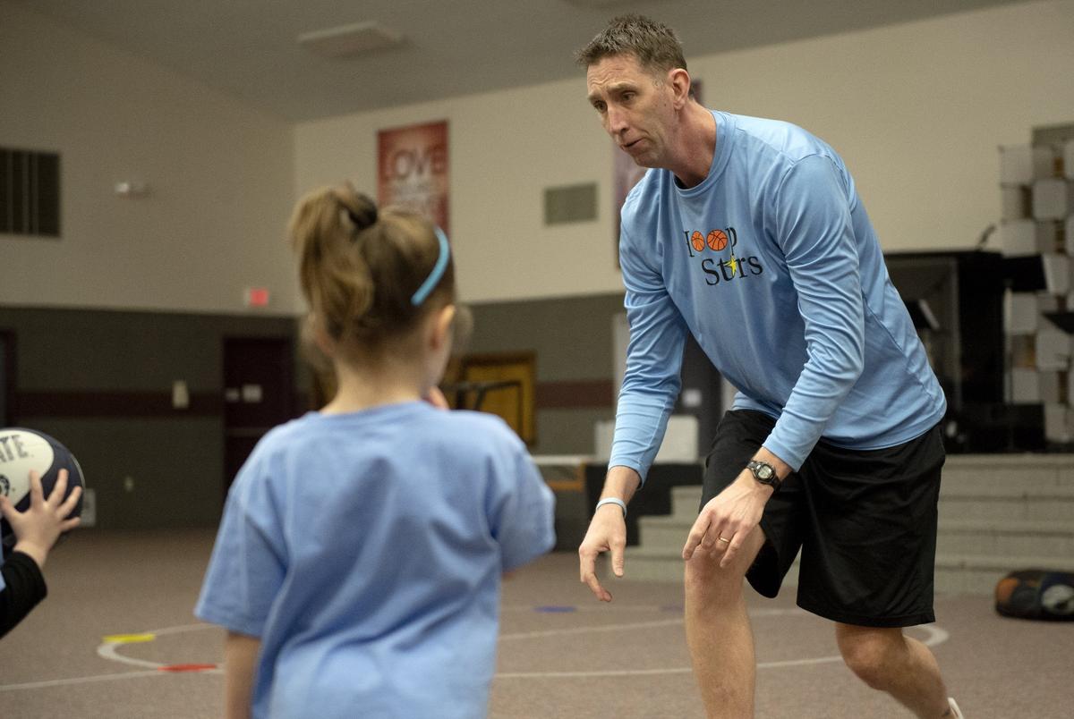 Dan McKenna encourages one of his preschoolers to make a chest pass during a Hoops Stars class at Park Forest Baptist Church on Monday, March 4, 2019.