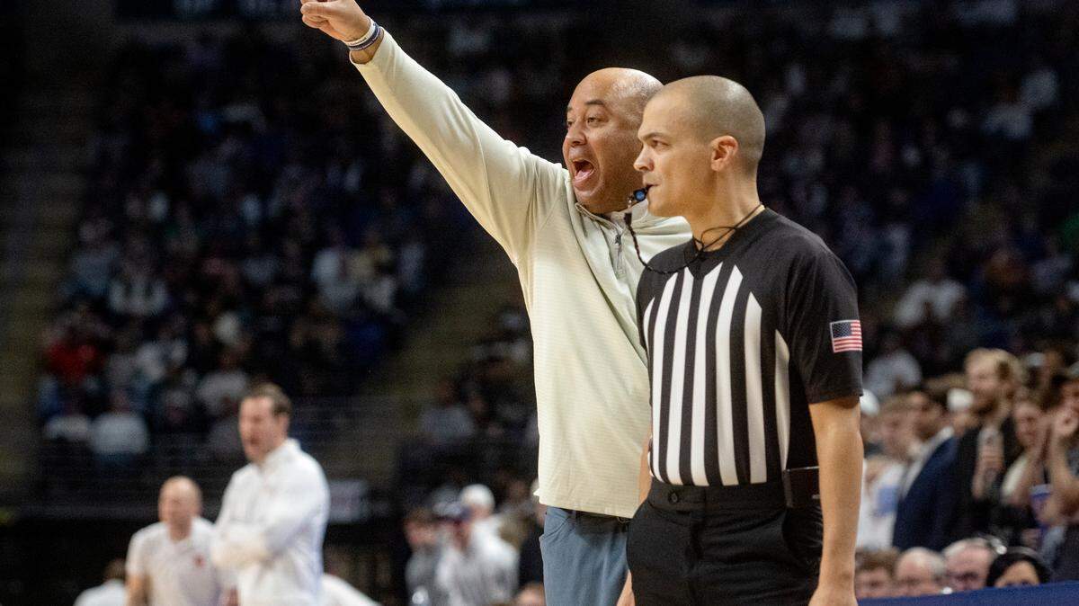 Penn State men’s basketball coach Micah Shrewsberry yells to his players around a referee during the game against Nebraska on Saturday, Jan. 21, 2023.