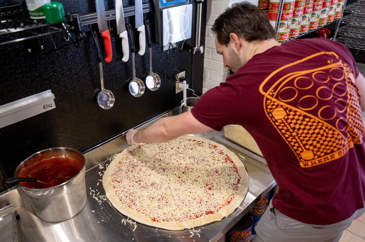 Colin Farrell makes a 28-inch pizza at Benny Leone’s at 109 S. Fraser St. on Wednesday, June 4, 2025.