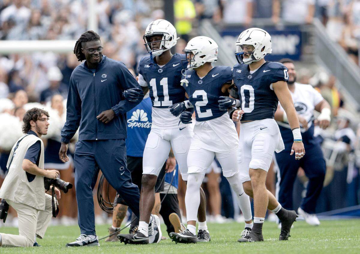 Penn State football captains Malick Meiga,Malik McClain, Keaton Ellis and Dom DeLuca walk out for the game against Delaware on Saturday, Sept. 9, 2023.