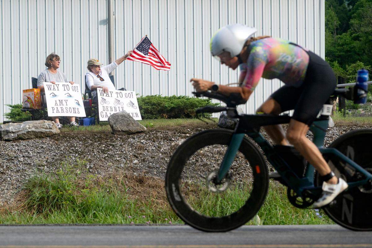 Paula Royer and Hope Kmisely cheer on cyclists as they compete in the 56 mile bike portion of Ironman 70.3 Pennsylvania Happy Valley on Sunday, June 30, 2024.