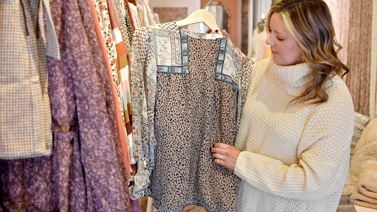 Emily Boon shows a blouse at By A Thread, a women’s clothing boutique on High Street in Bellefonte, in November 2020. The boutique won the Business of the Year Award handed out by Downtown Bellefonte Inc.