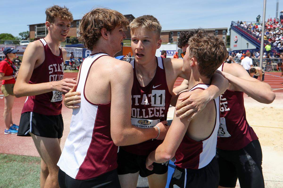 State College’s Nick Sloff, center, hugs his teammates after crossing the finish line first in their heat, but placing third overall with a time of 7:48.47 in the boys Class 3A 4x800 meter relay finals during the PIAA State Track and Field Championships held Saturday at Seth Grove Stadium on the Shippensburg University campus in Shippensburg.