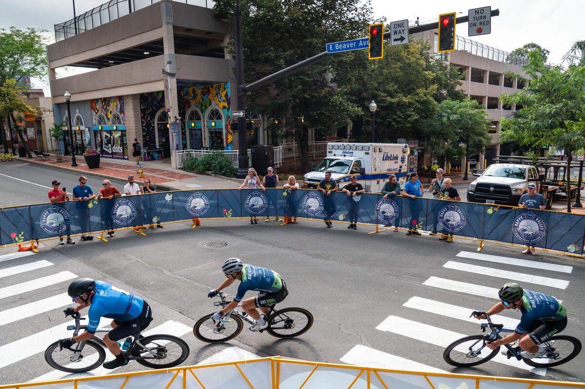 Participants in the Men’s Cat 1 and Cat 2 cycling race go around a corner during the State College Criterium on Saturday, July 26, 2025 in State College, Pa.