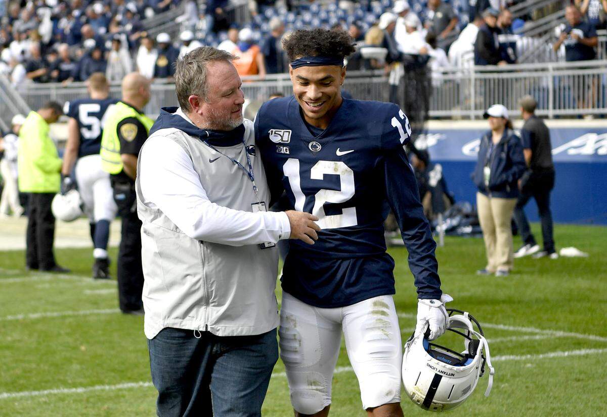 Penn State baseball coach Rob Cooper congratulates Penn State wide receiver Mac Hippenhammer, who also plays baseball after the win over Pitt on Saturday, Sept. 14, 2019.