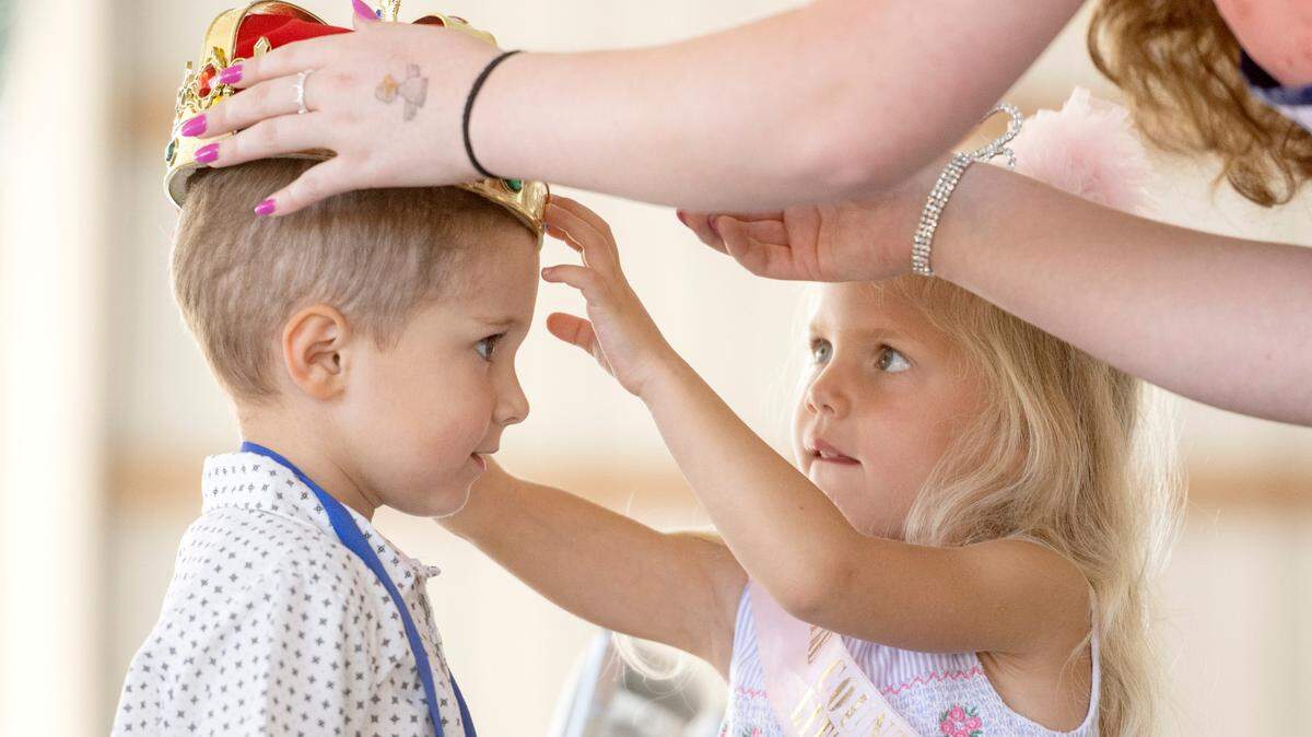 The 2021 Grange Fair Little Queen Alison Glasgow, 4, helps crown the 2022 Grange Fair Little King Declan Wert, 3, during the Grange Fair Little King and Queen contest on Wednesday, Aug. 24, 2022.