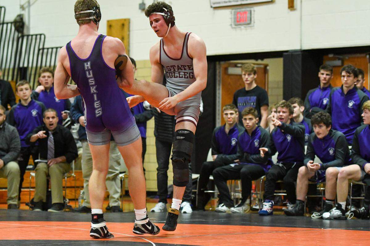 State College’s Ty Price looks to escape a takedown attempt from Mifflin County’s Jacob Krepps in their 195-pound bout during the Little Lions’ 25-24 win in the District 6 Class 3A Championship. Price beat Krepps 2-1.