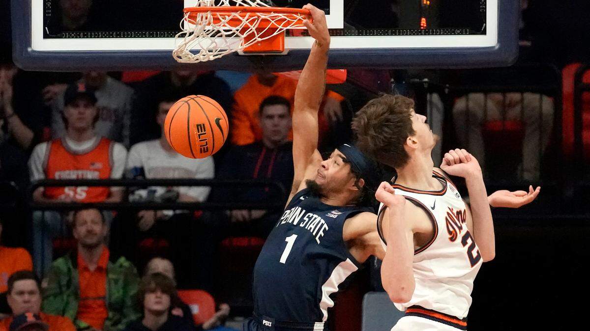 Penn State’s Seth Lundy (1) dunks past Illinois ‘s Matthew Mayer during the first half of an NCAA college basketball game Saturday, Dec. 10, 2022, in Champaign, Ill. (AP Photo/Charles Rex Arbogast)